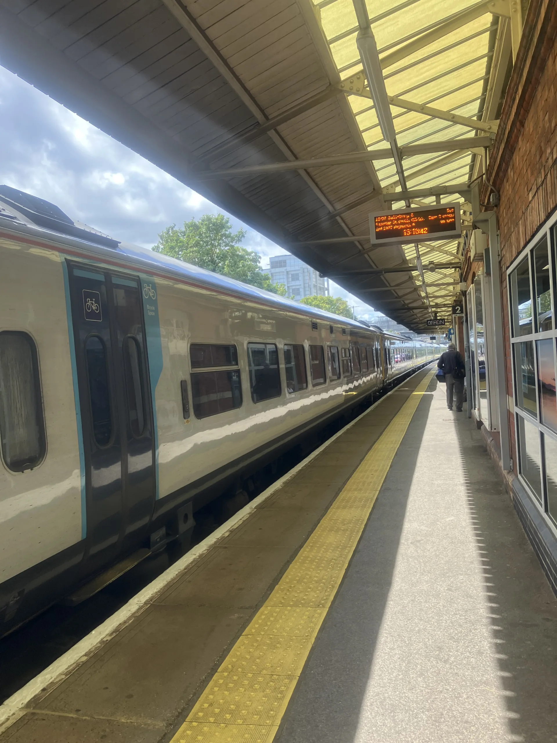 Train in station, waiting at platform.