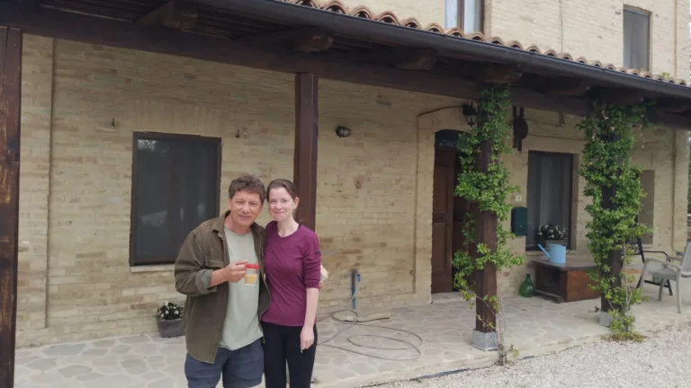 Seva and Rose standing in front of farmhouse in Le Marche, Italy.