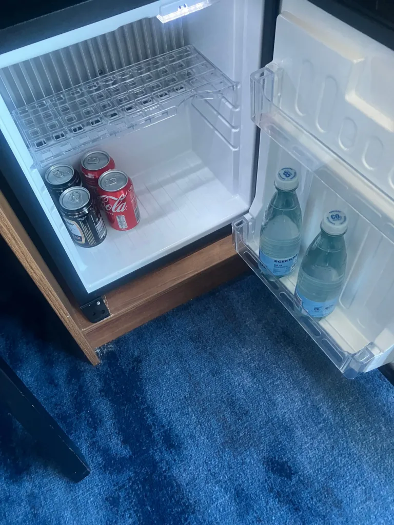 Mini bar with soda, beer, and water.