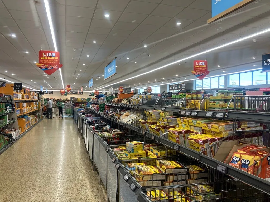 Aisle in Aldi with strong overhead lights.