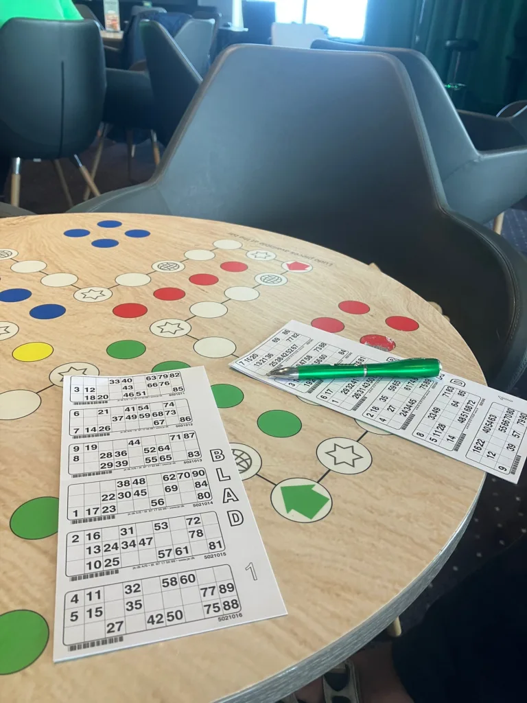 Bingo cards sitting on a wooden table.