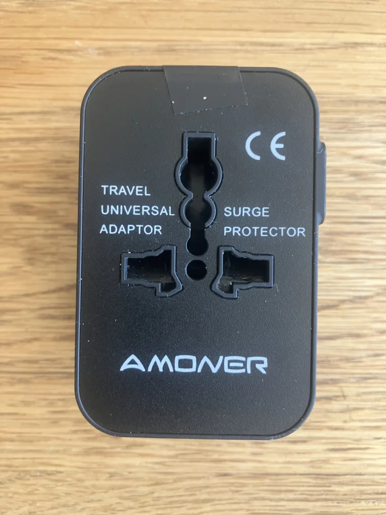 Black electrical adapter on a wood floor.
