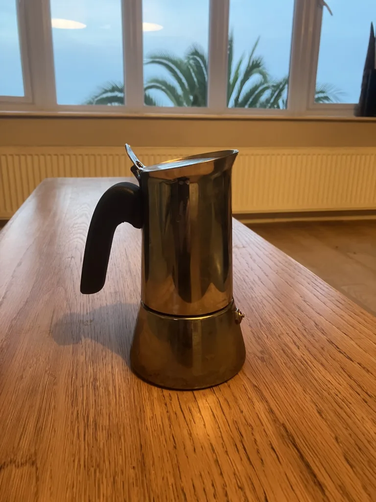 Picture of Moka espresso pot on wood table.