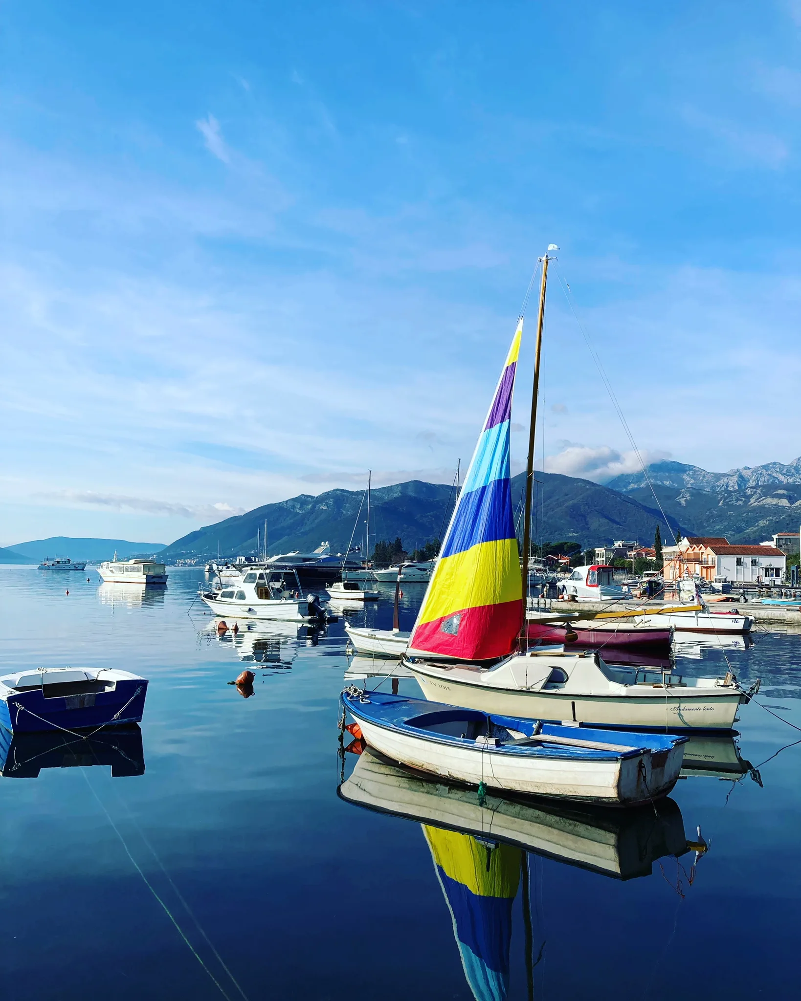 Boat with rainbow sail in Tivat