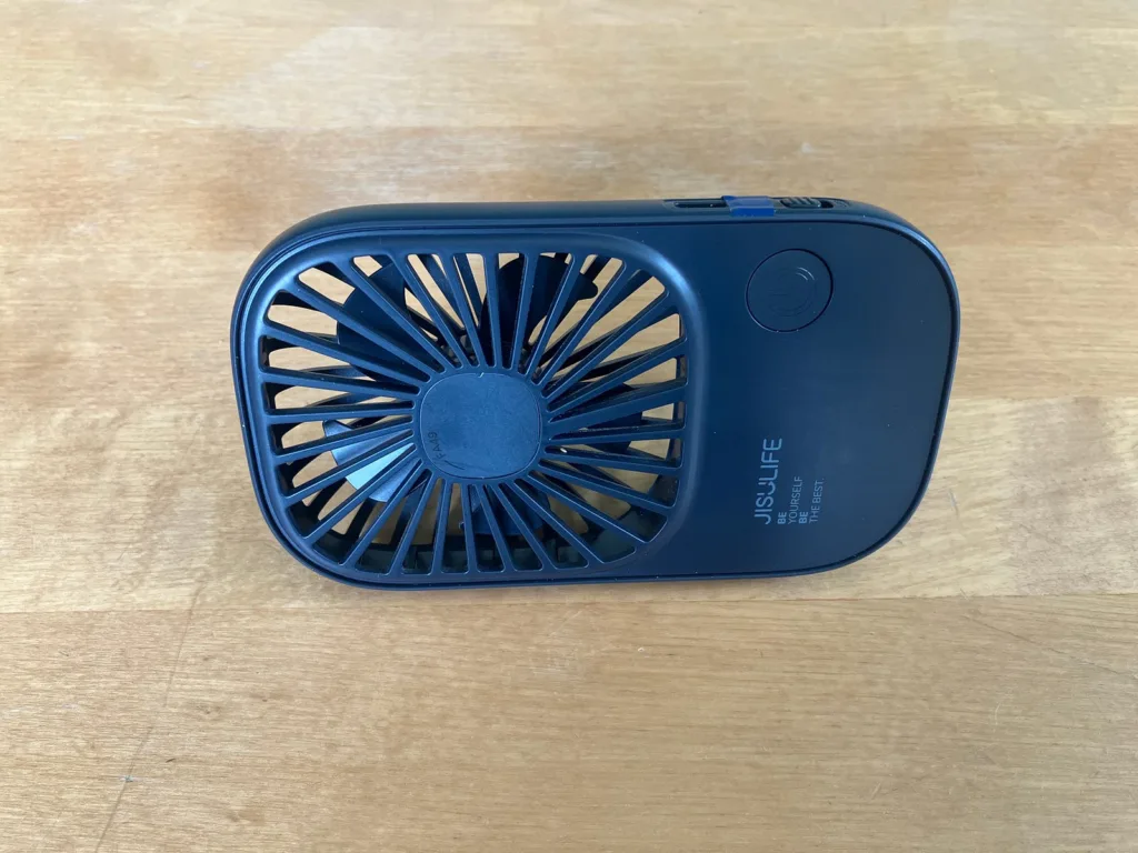 Gray rectangular usb fan on wooden table.